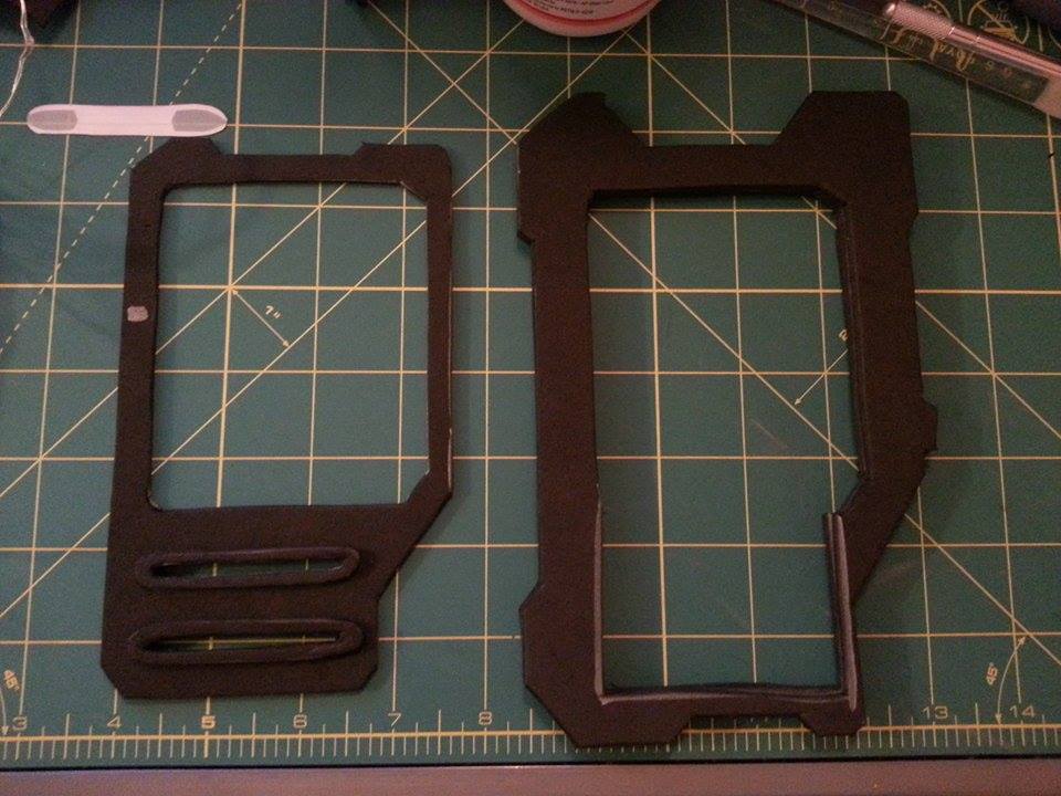 Glued the first 3 layers together and cut out a space for the battery pack. It'll be hidden by the face place. Cut out the spaces for the light bars. The silver dot I need to cut out and then fill with red tinted glue for the "on" light.